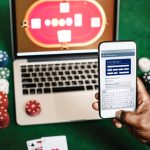 hand-holding-card-playing-online-gambling